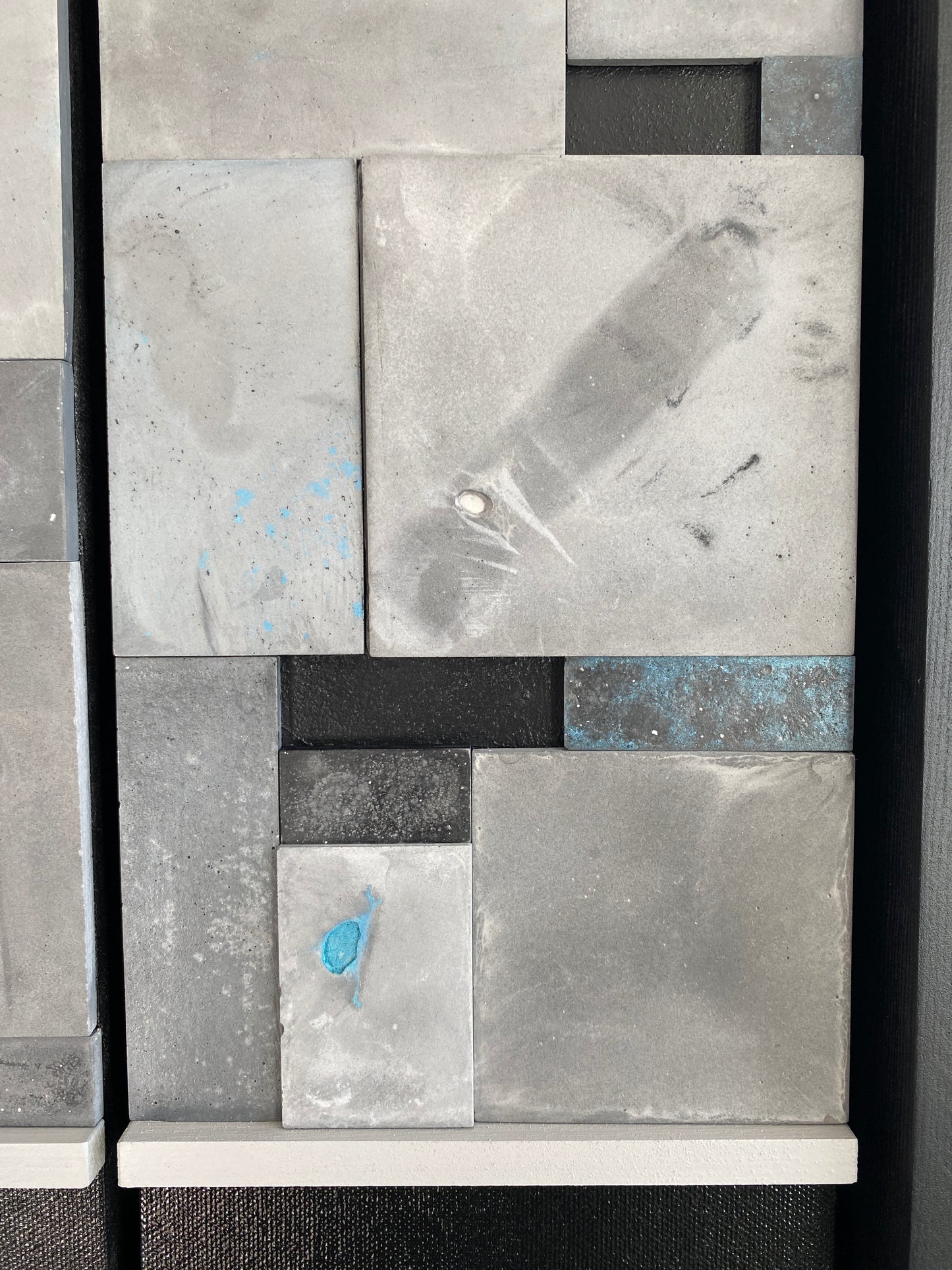 Abstract art piece with geometric shapes and textures on a black background