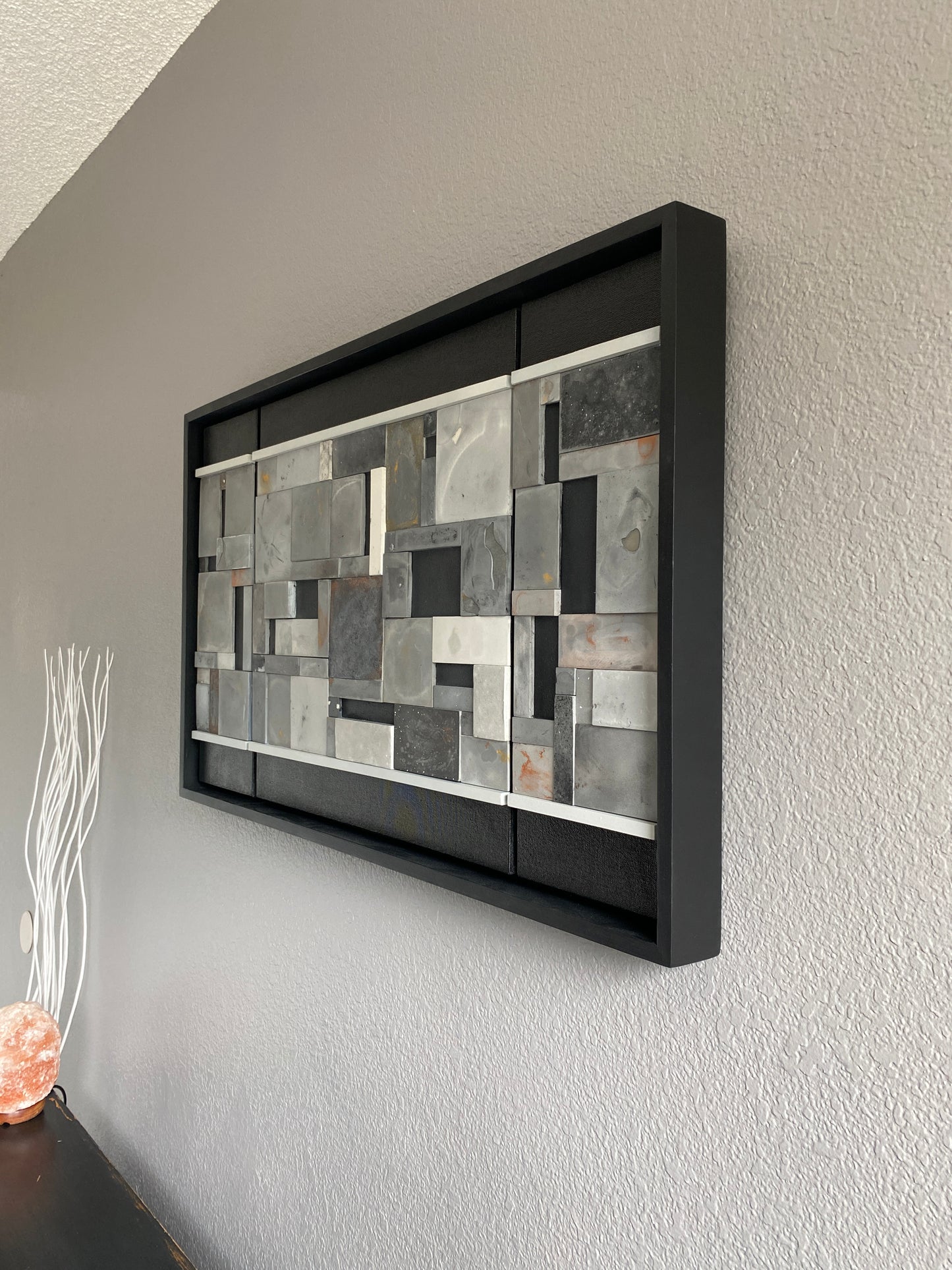 Left view of mosaic wall art triptych with golds and bronze in black floating frame.