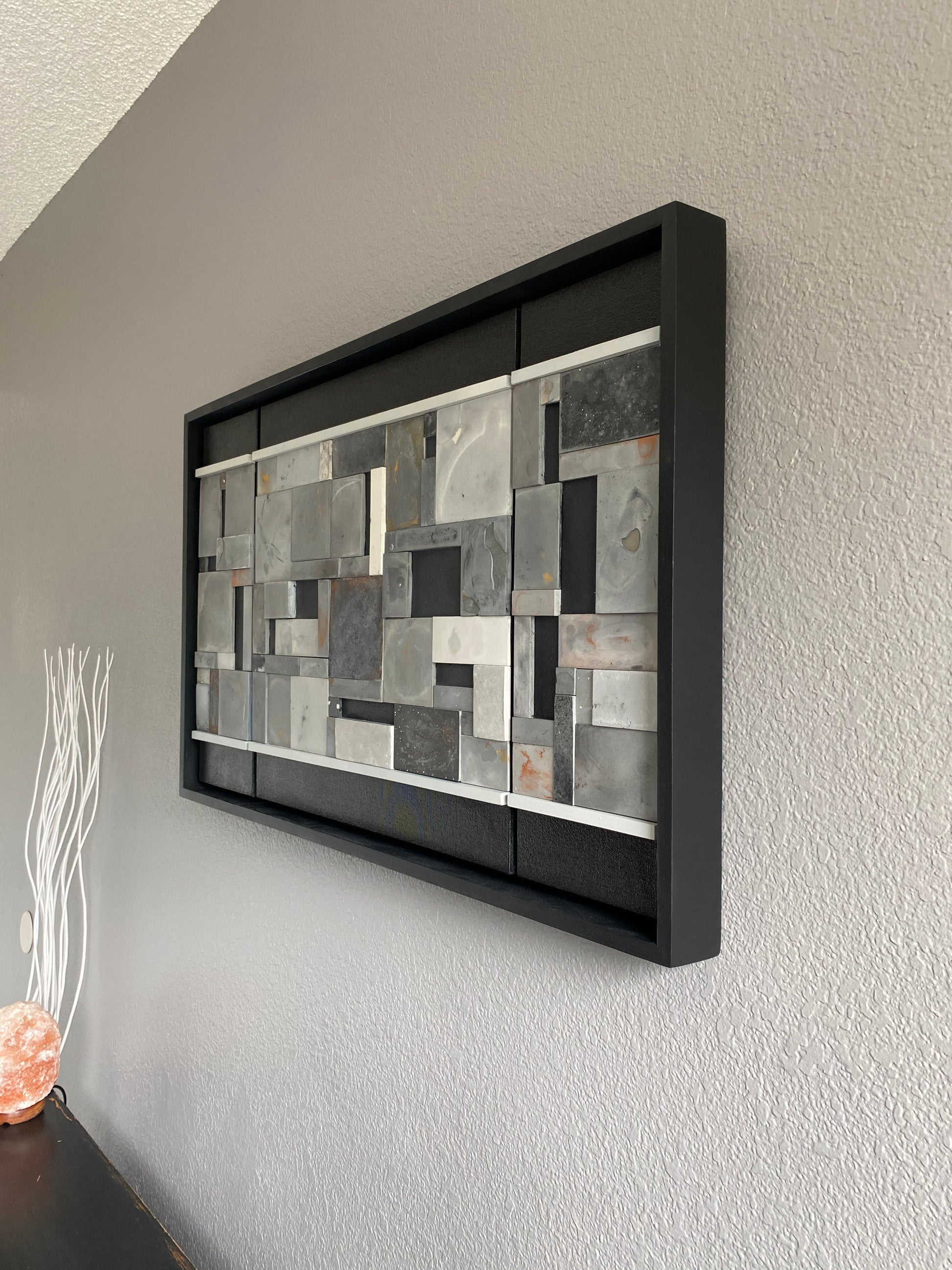 Left view of mosaic wall art triptych with golds and bronze in black floating frame.
