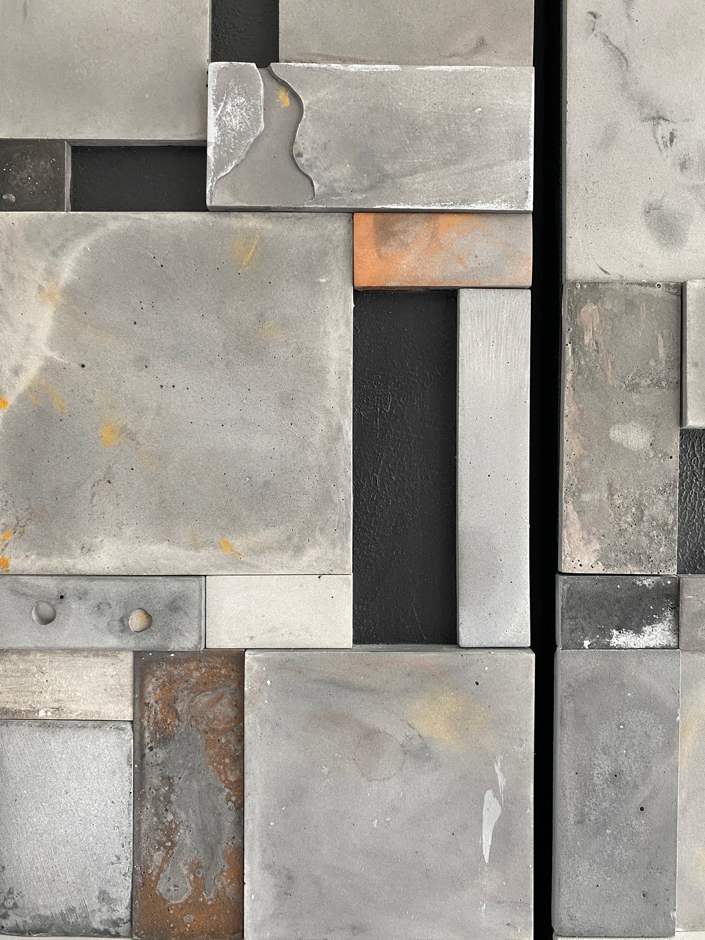 Upclose photo of mosaic wall art triptych with golds and bronze in black floating frame.