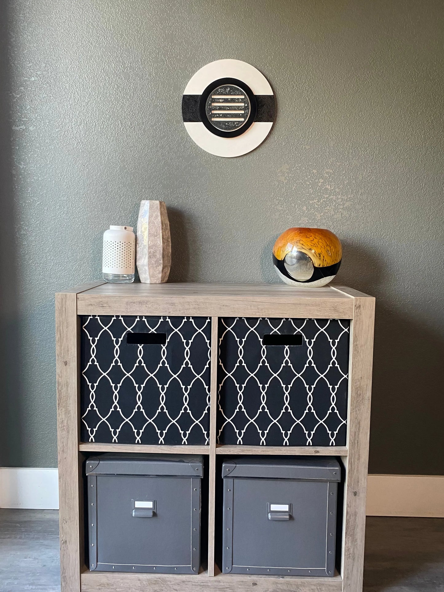 Front view of memorial wall art showing black ring, textured black stripe, and handcrafted white frame