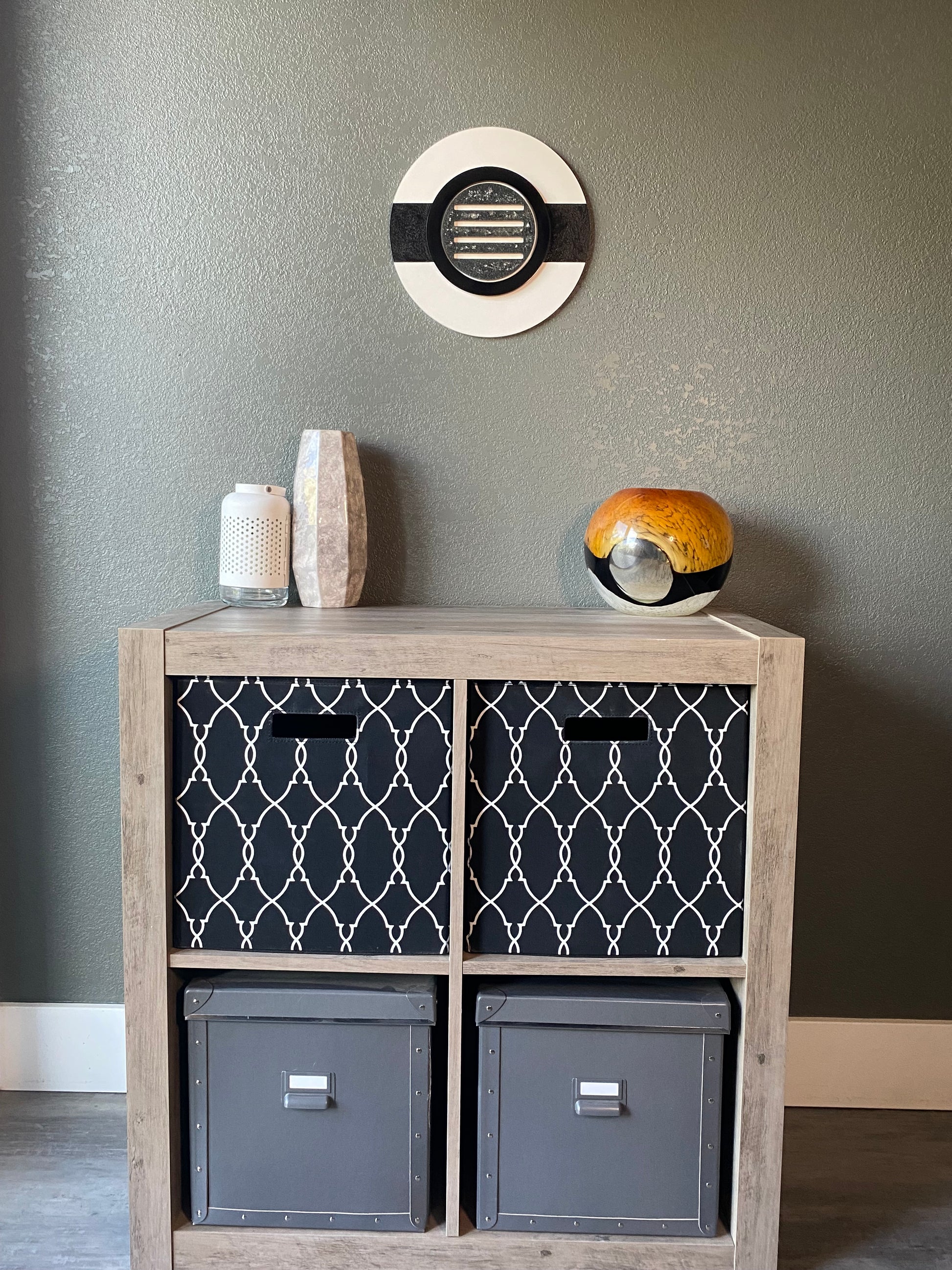 Front view of memorial wall art showing black ring, textured black stripe, and handcrafted white frame