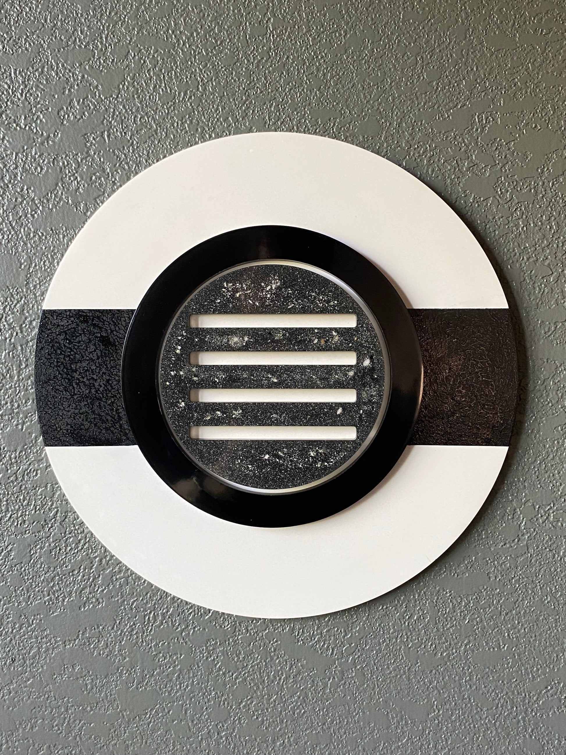 Peekaboo cremation ash memorial wall art with black ring and resin peepholes on white frame