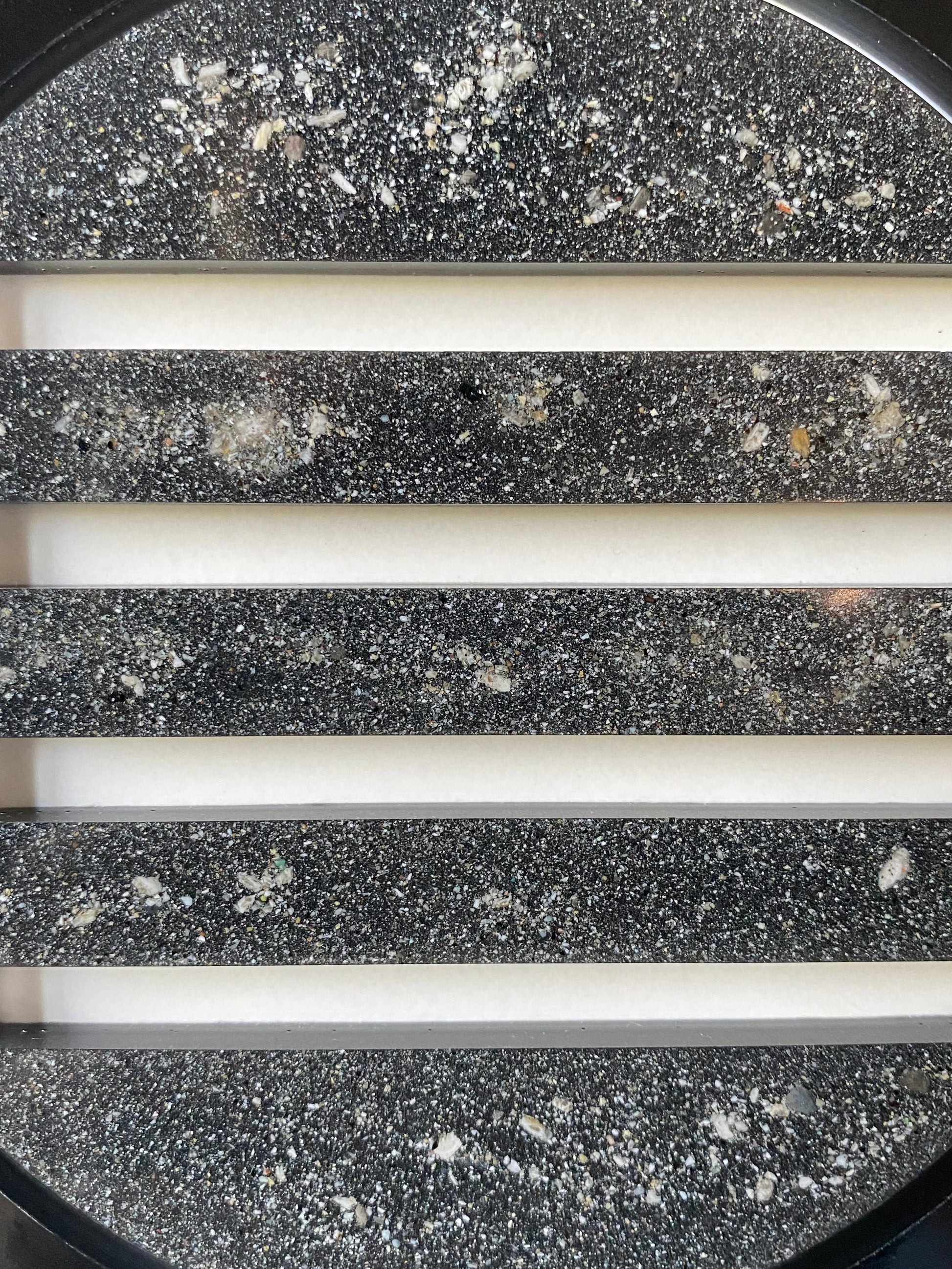 Close-up of resin peepholes infused with cremation ash, symbolizing trust and permanence