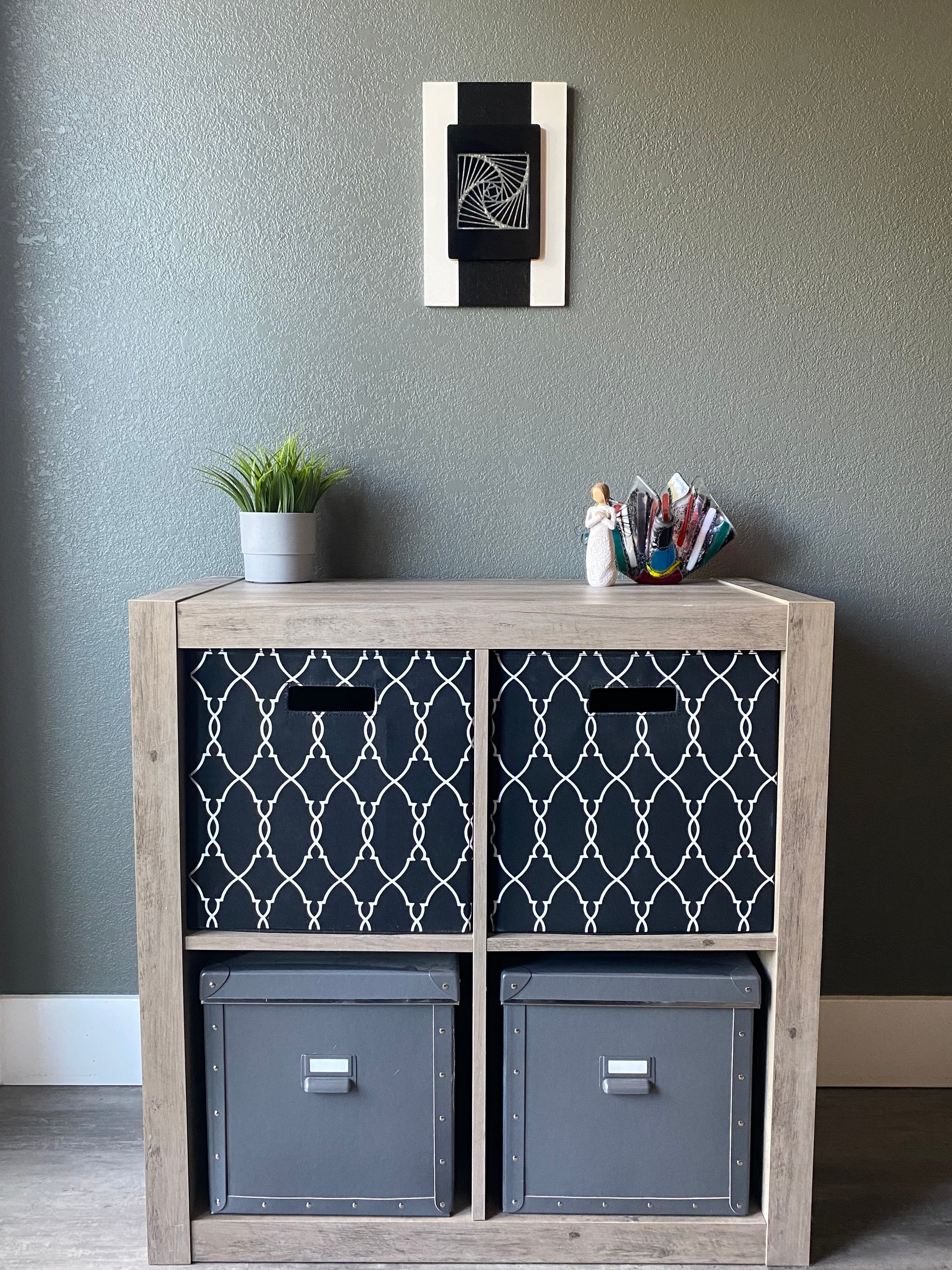 Front view of memorial wall art showing textured black stripe, spiraling resin, and handcrafted white frame