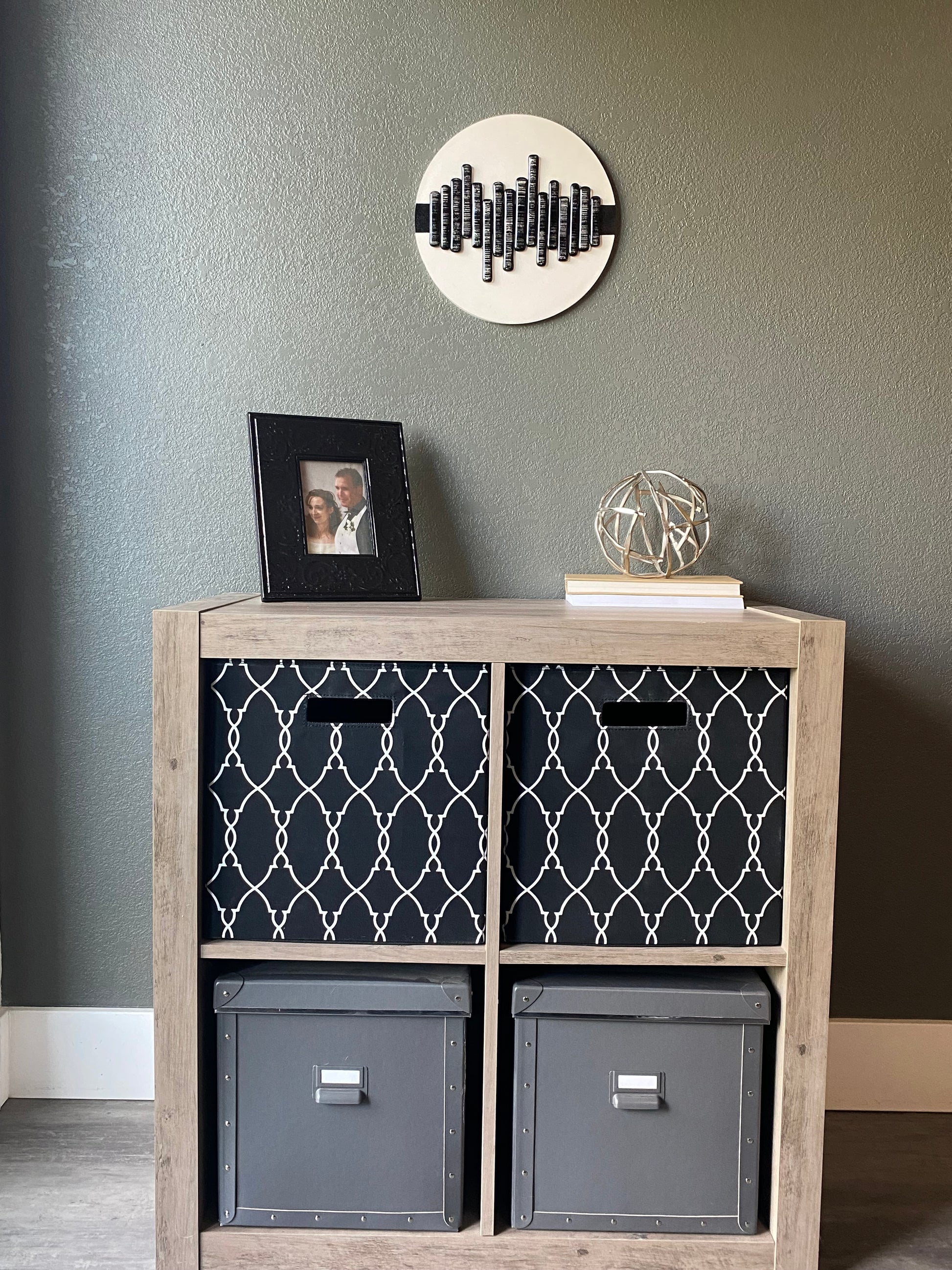 Front view of memorial wall art showing textured black stripe, glass soundwave pattern, and handcrafted white frame
