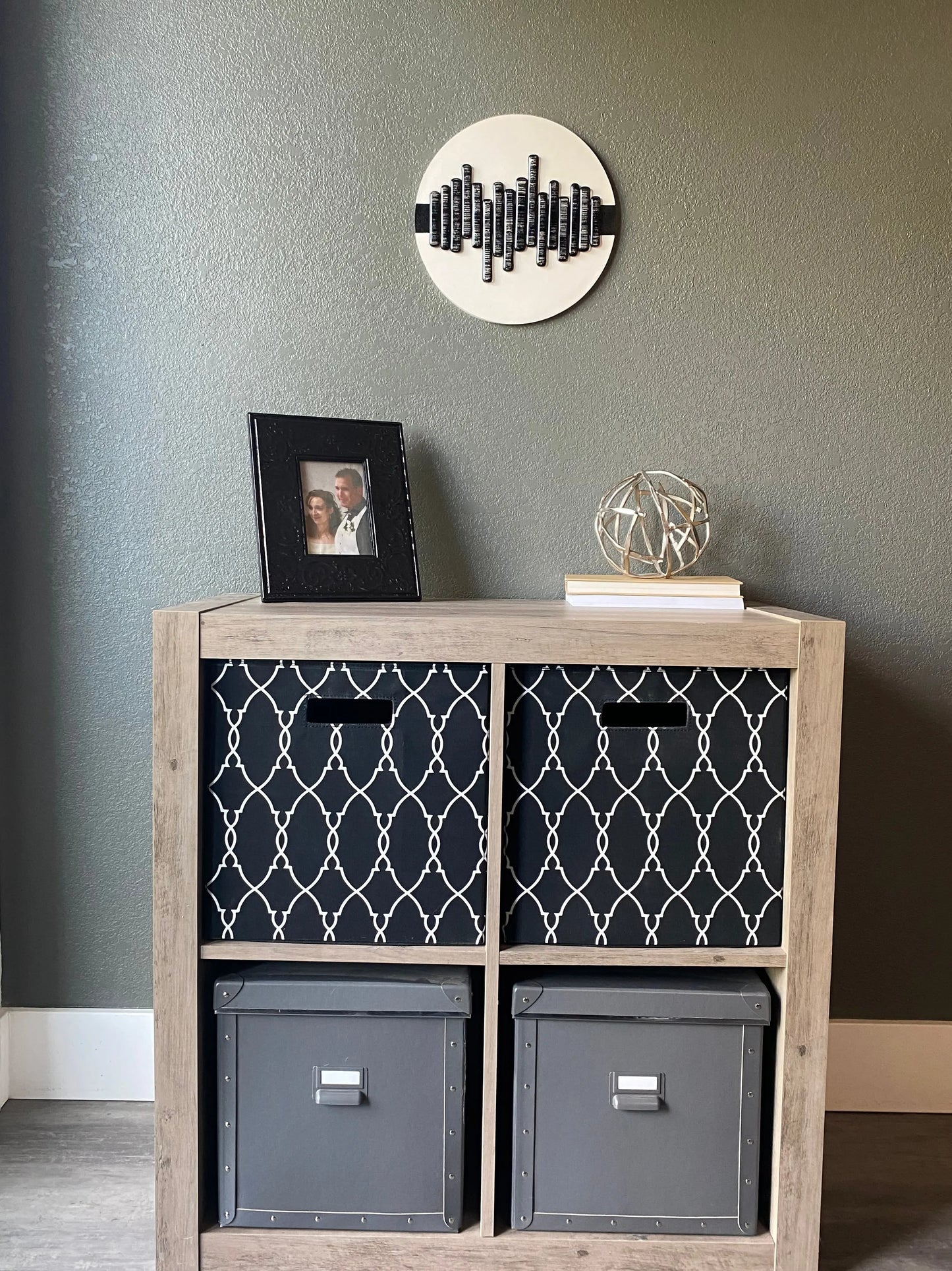 Front view of memorial wall art showing textured black stripe, glass soundwave pattern, and handcrafted white frame