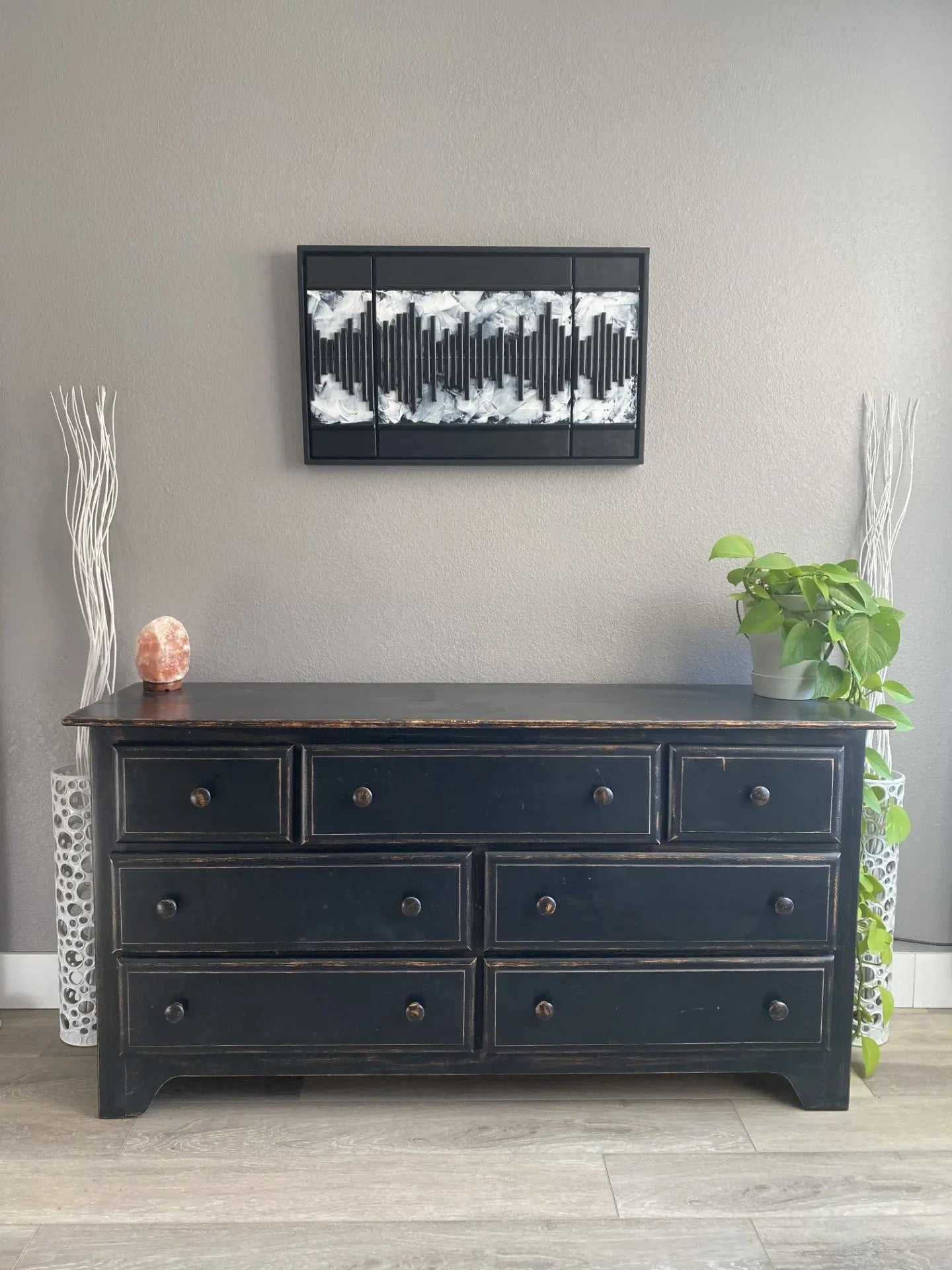 Black‑and‑white mixed‑media artwork featuring a vertical soundwave pattern made from layered acrylic, resined wood, and metal on a handmade cradled panel, framed in a custom floating frame