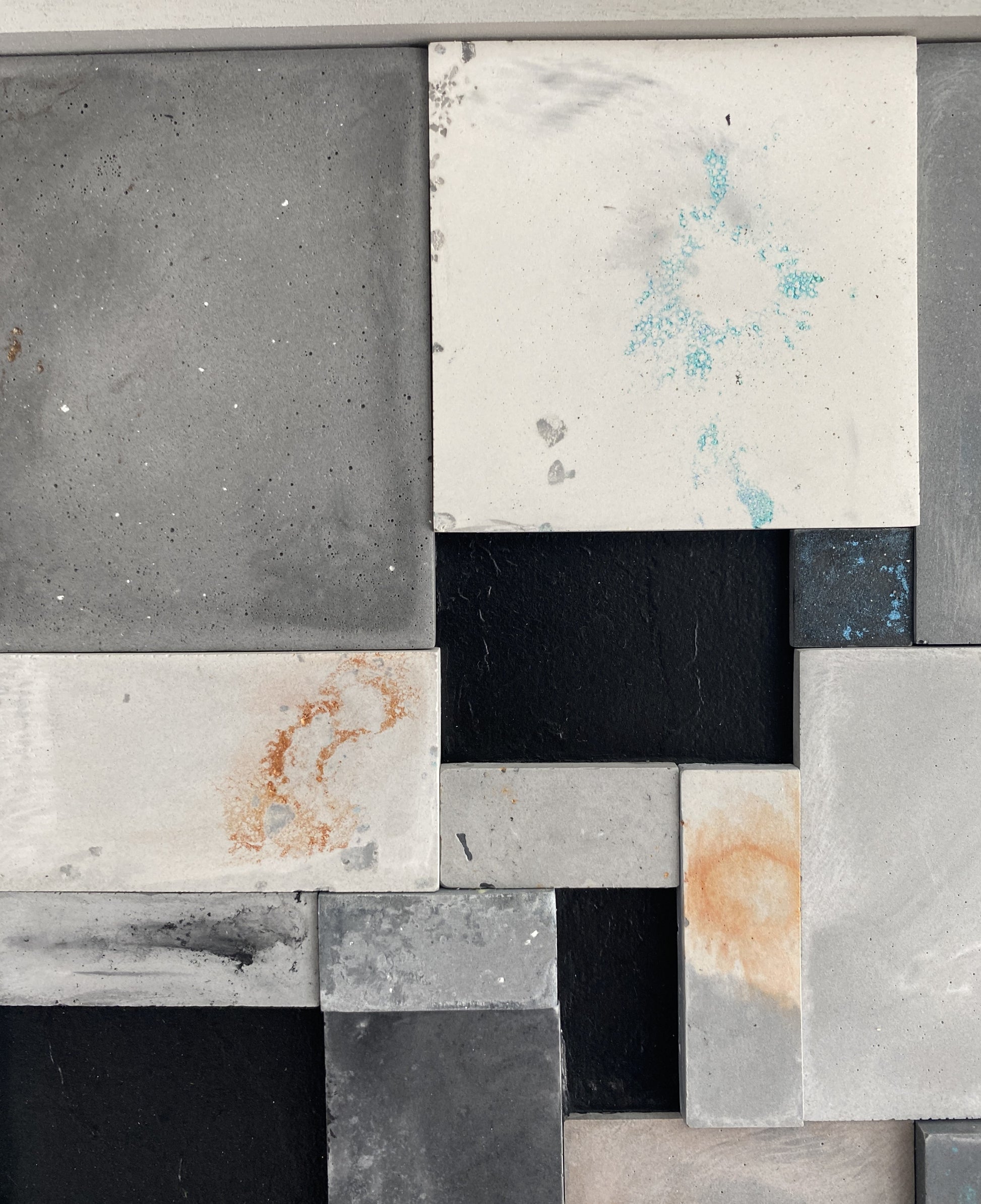 Close-up of a mosaic pattern with various stone tiles in different colors and textures.