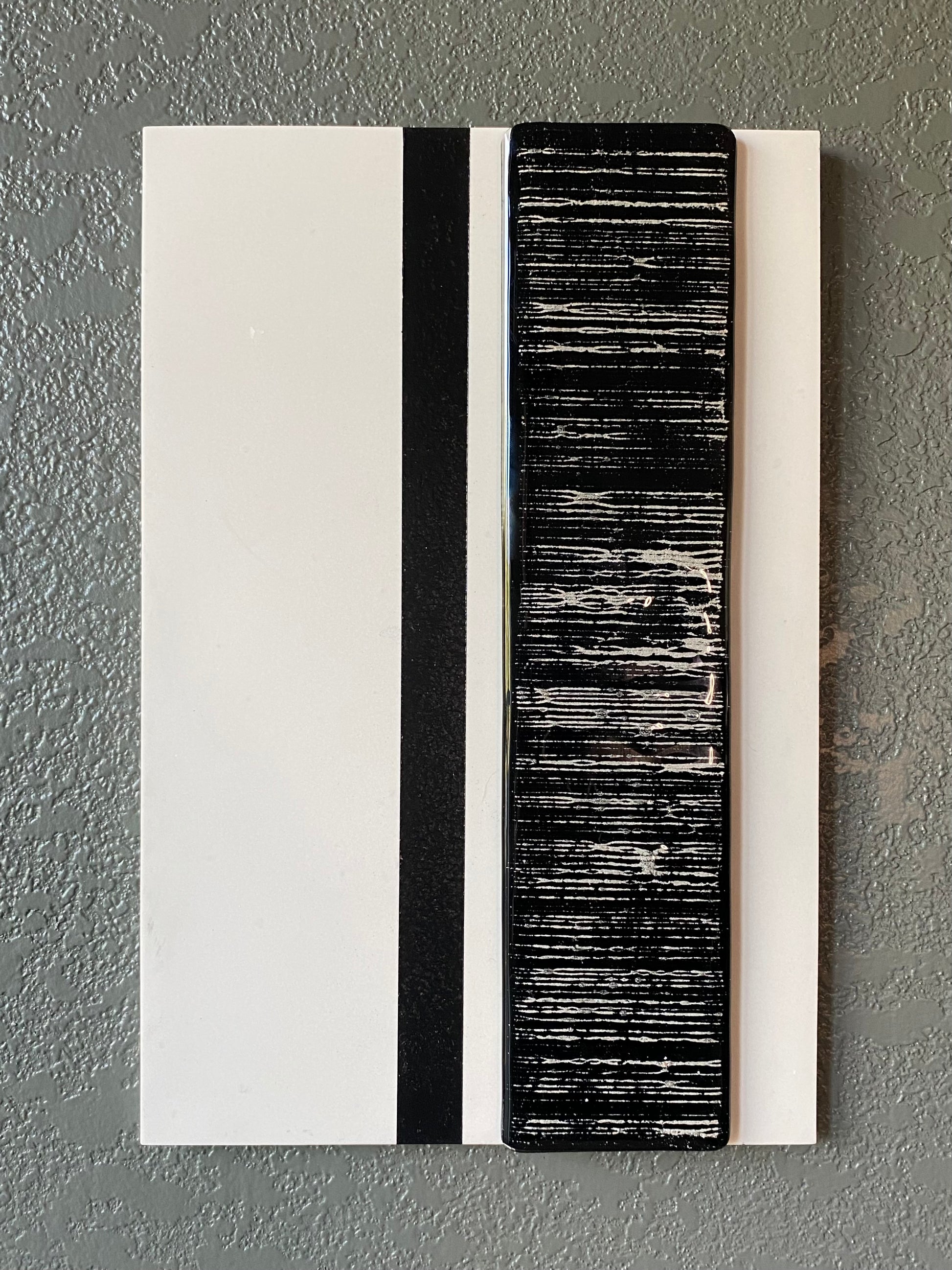 Striped cremation ash memorial wall art with flowing glass stripes on white frame and vertical black accent