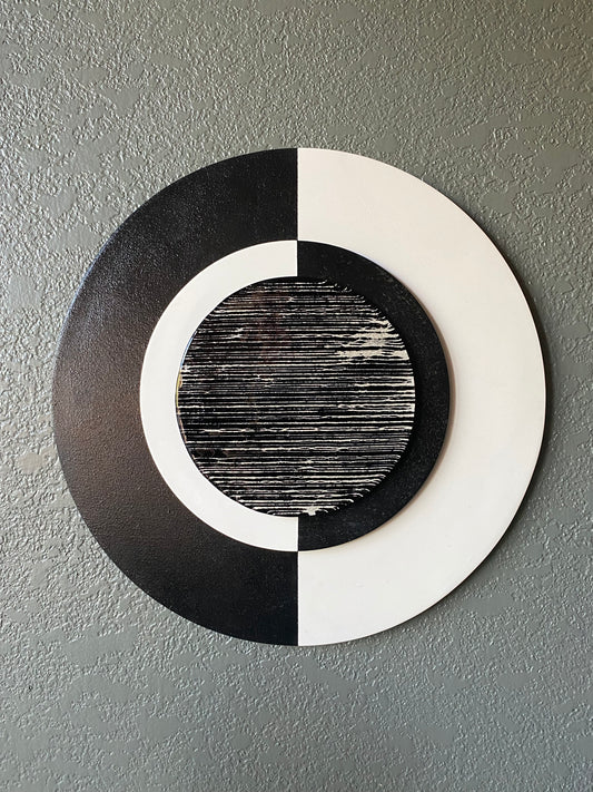 Front view of memorial wall art showing black and white frames, yin yang glass, and textured black stripe