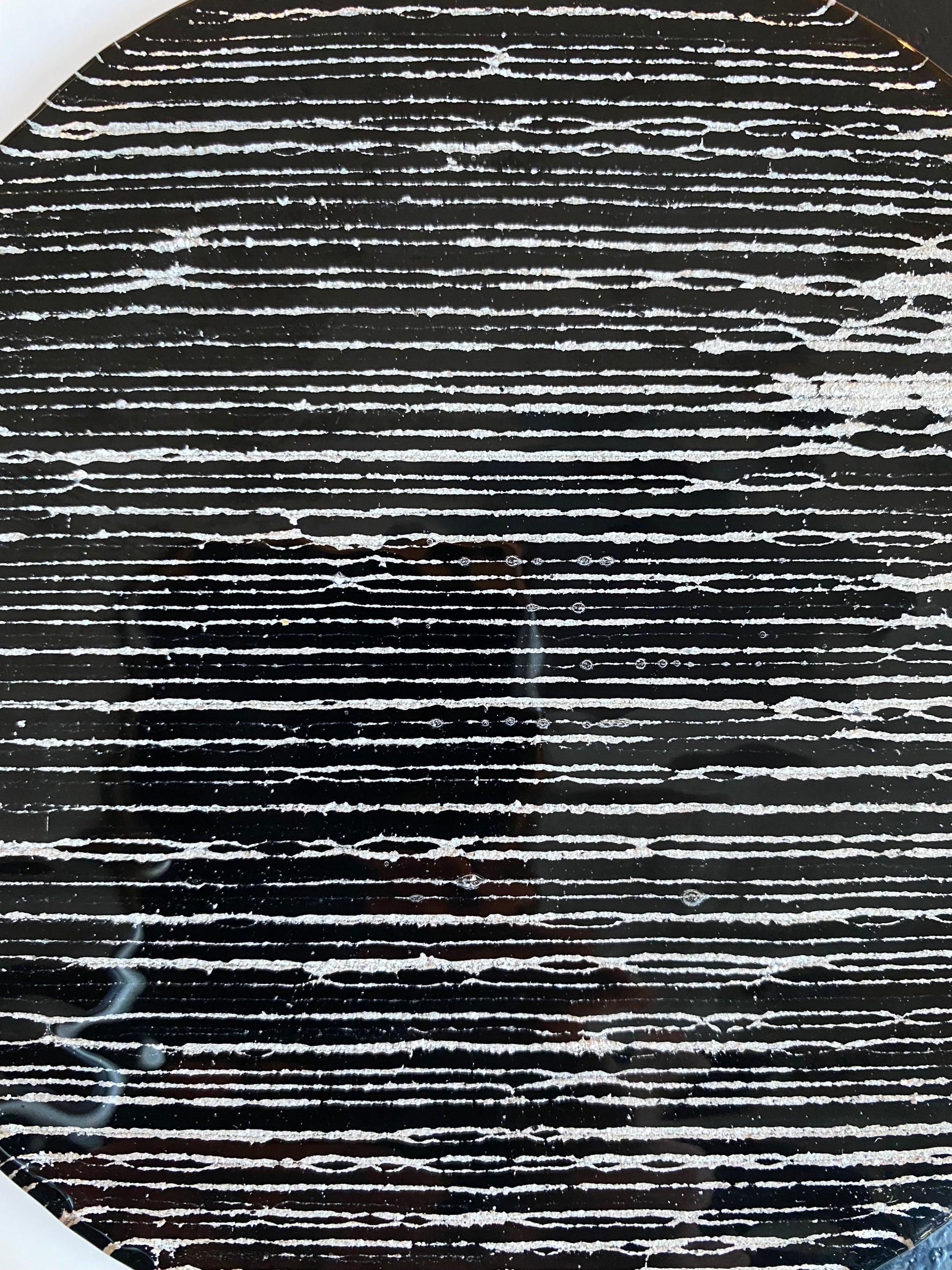 Close-up of yin yang glass infused with cremation ash, symbolizing balance and eternal connection