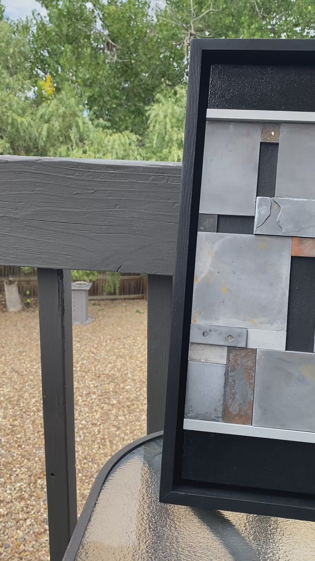 Mosiac Wall Art outside showing the glimmers and shimmers of color on table.