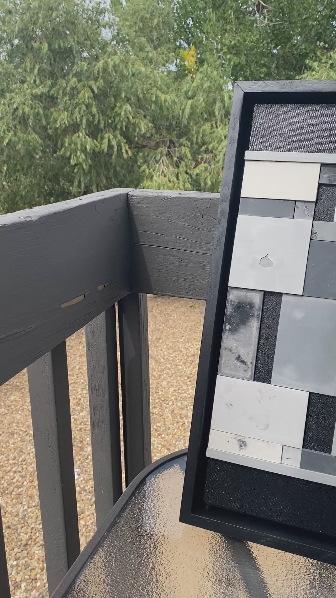 Geometric abstract art sitting on table outside.