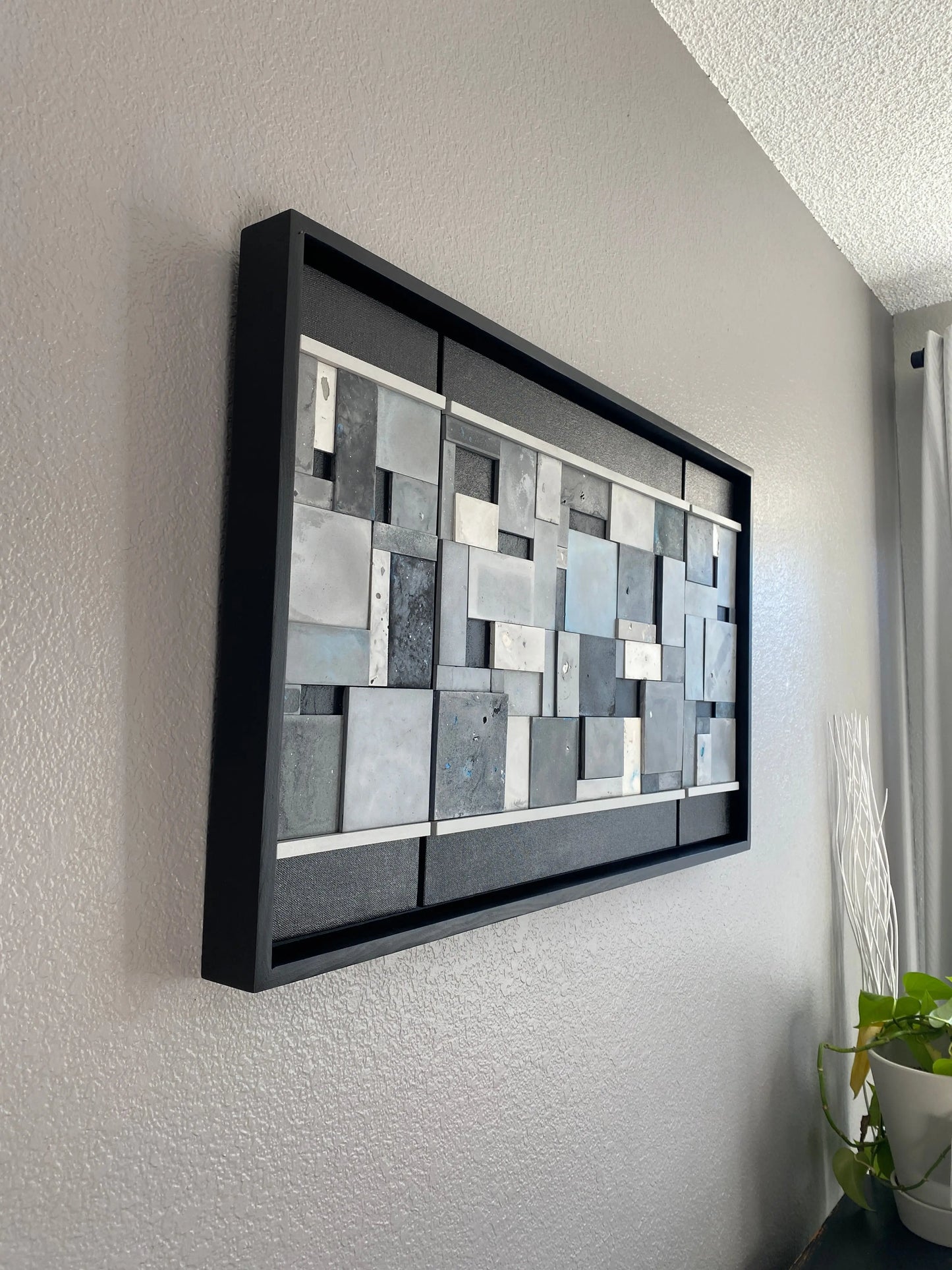 Decorative art piece with mosaic design on a gray surface