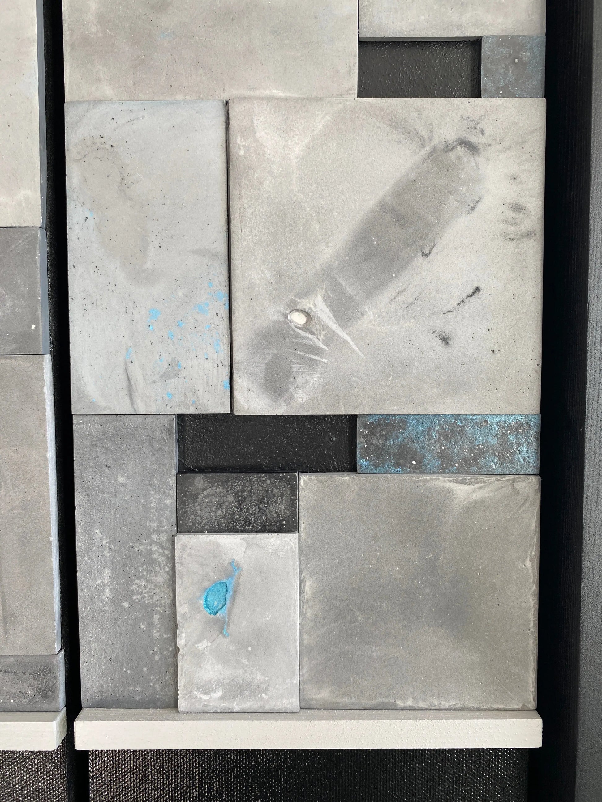 Abstract art piece with geometric shapes and textures on a black background