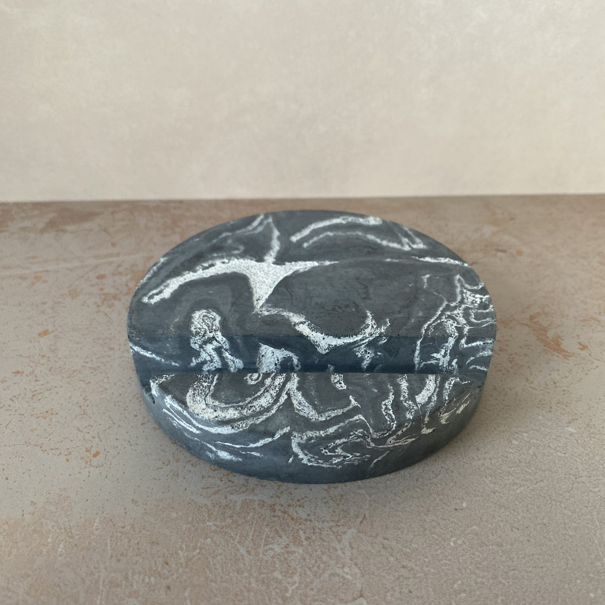 Gray and white round marbled concrete stand.