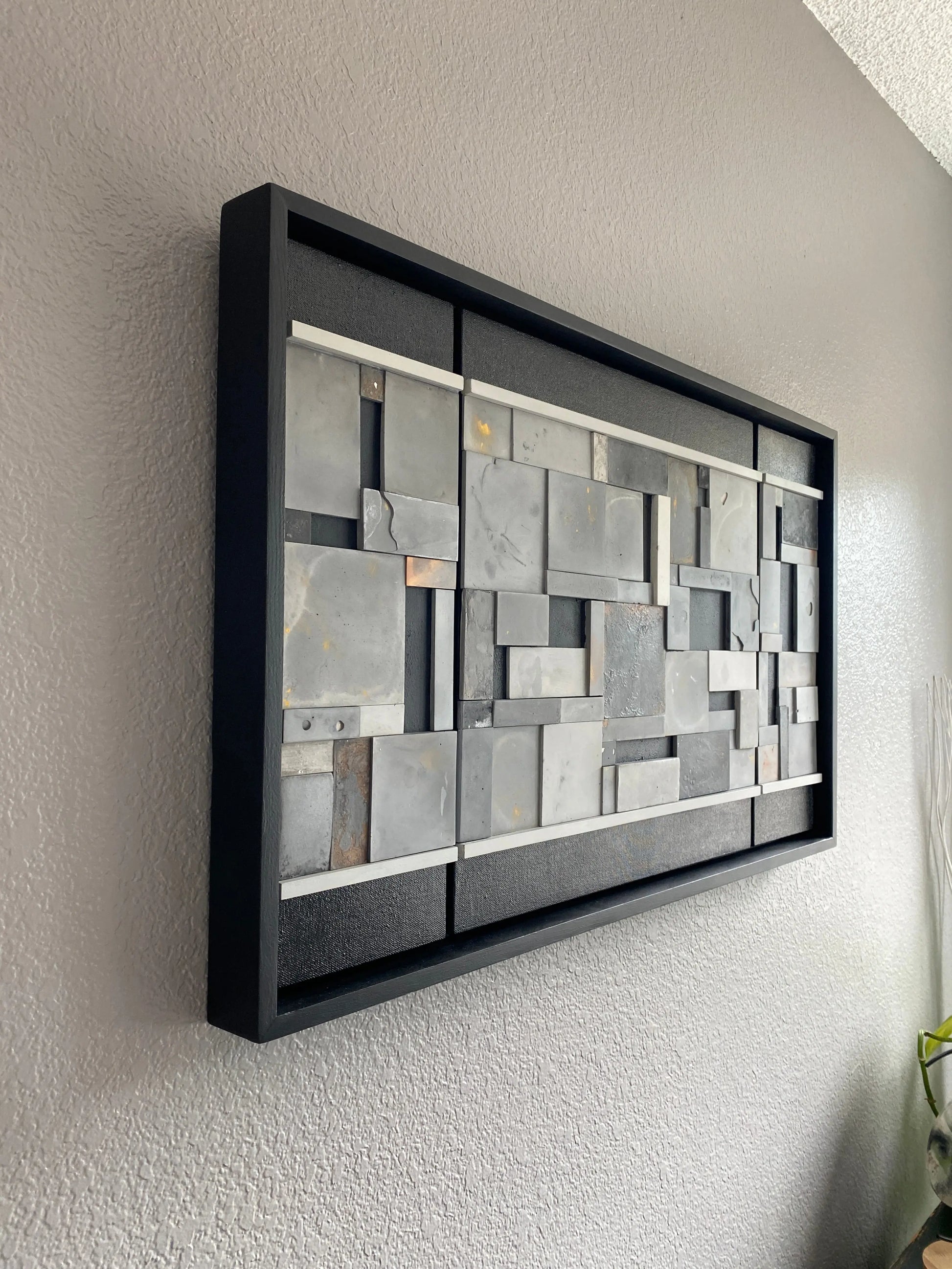 Right view of mosaic wall art triptych with golds and bronze in black floating frame.