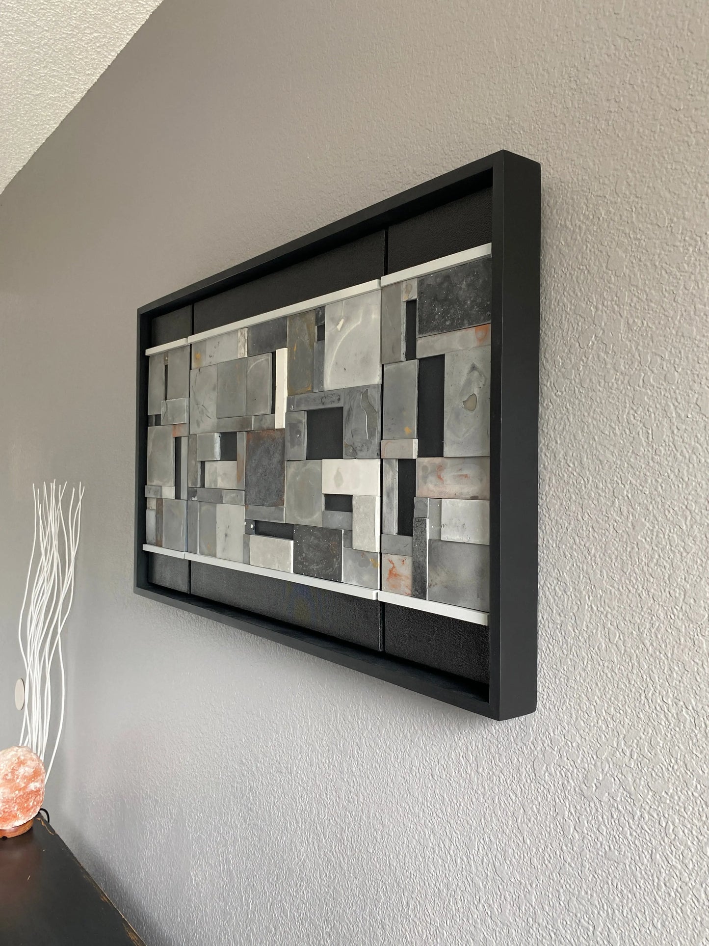Left view of mosaic wall art triptych with golds and bronze in black floating frame.