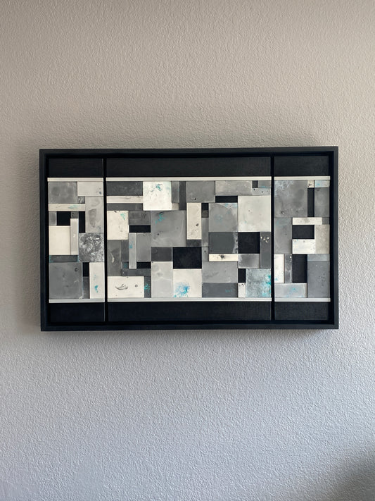 Close-up of Ocean’s Memory showing layered acrylic resin tiles with shimmering mica pigments and textured paint details on grey wall.
