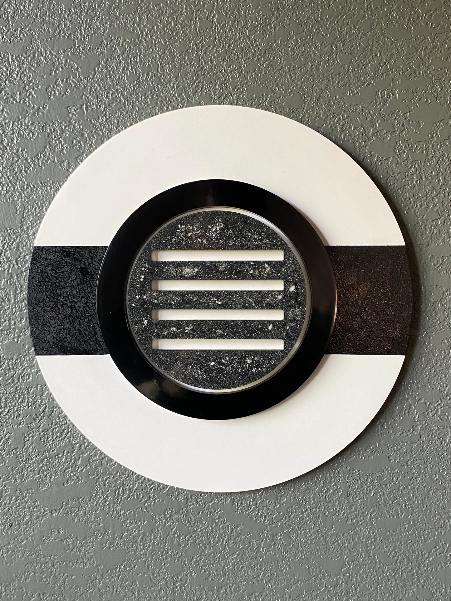 Peekaboo cremation ash memorial wall art with black ring and resin peepholes on white frame