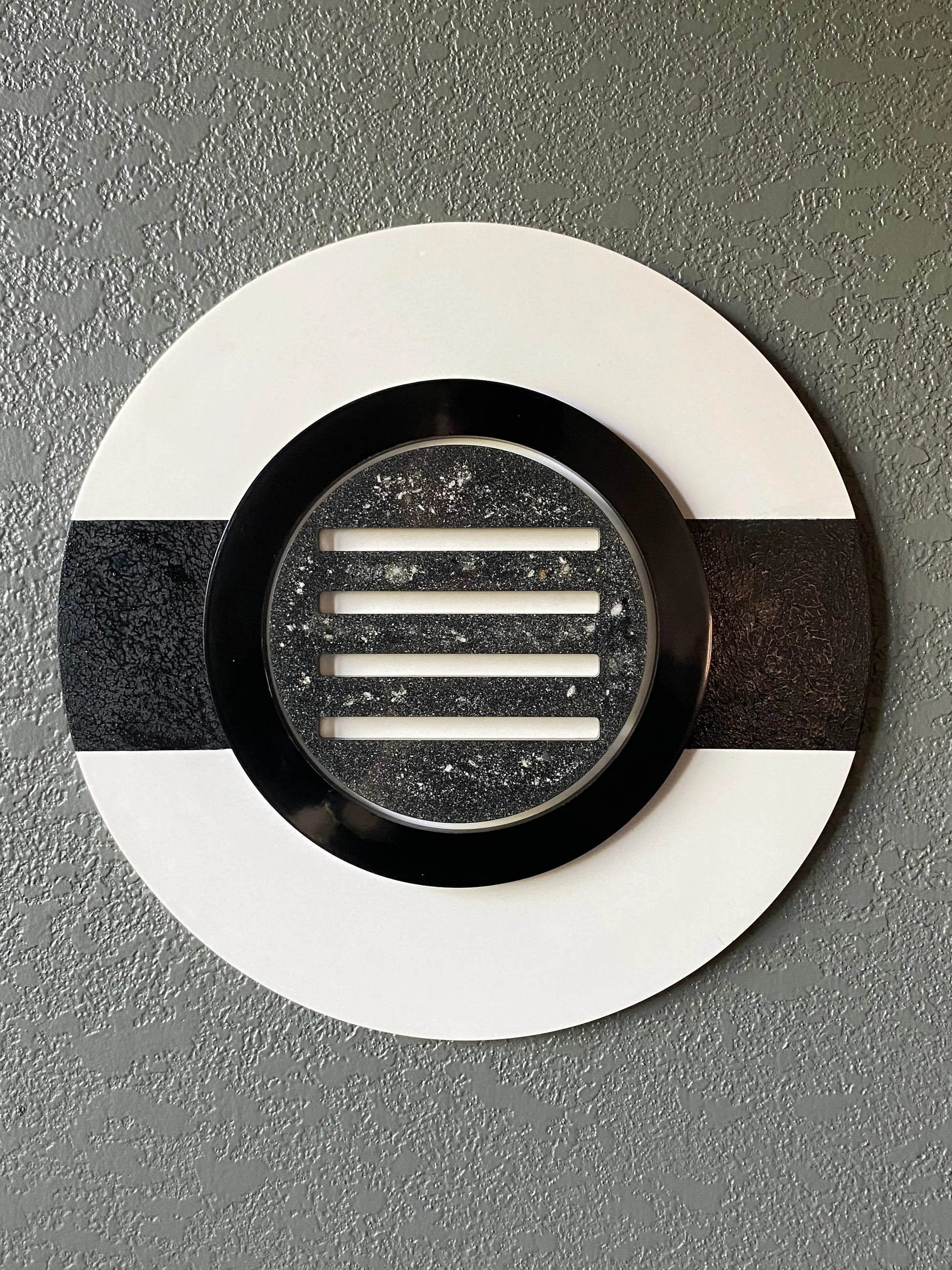 Peekaboo cremation ash memorial wall art with black ring and resin peepholes on white frame