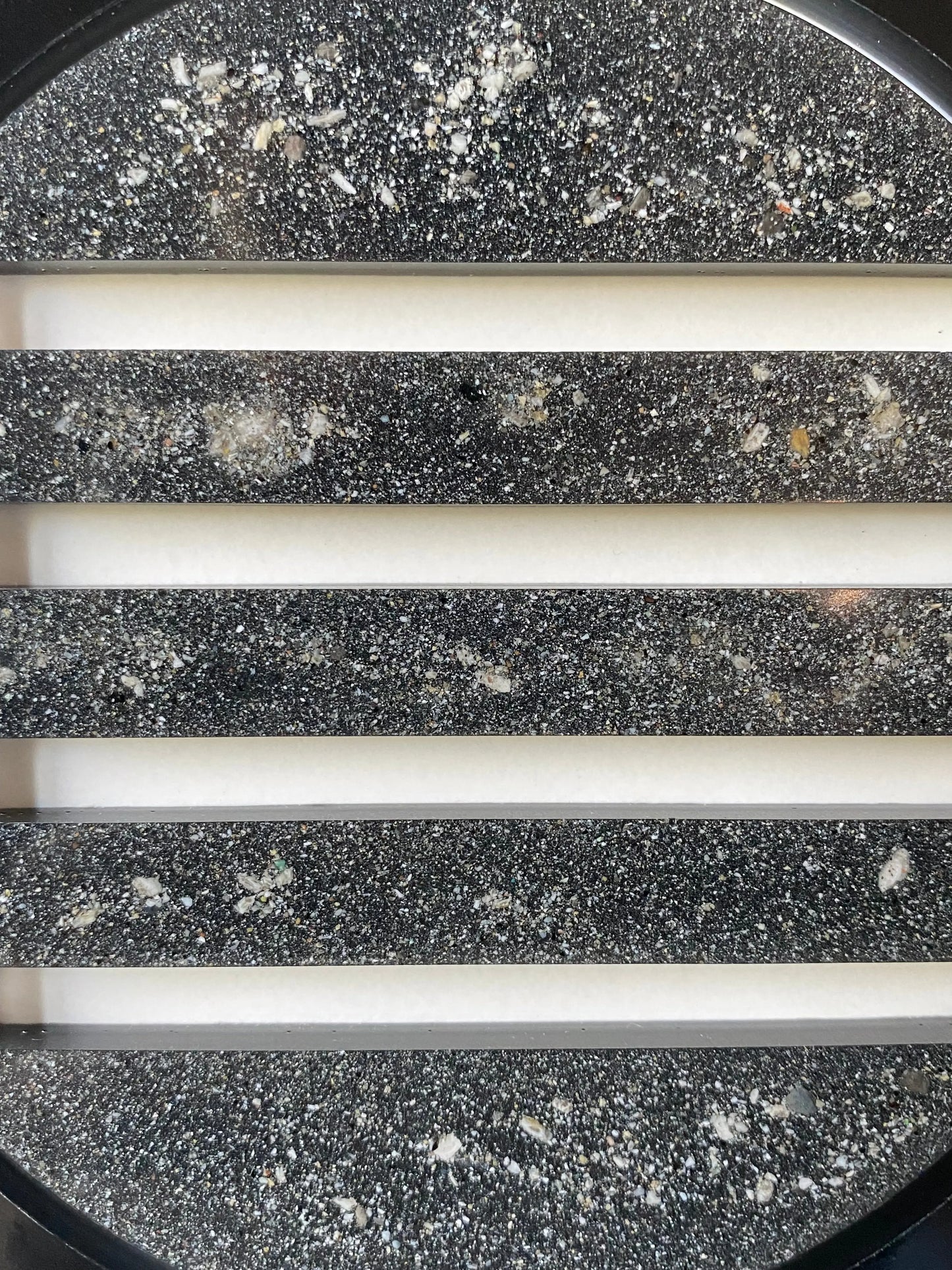 Close-up of resin peepholes infused with cremation ash, symbolizing trust and permanence