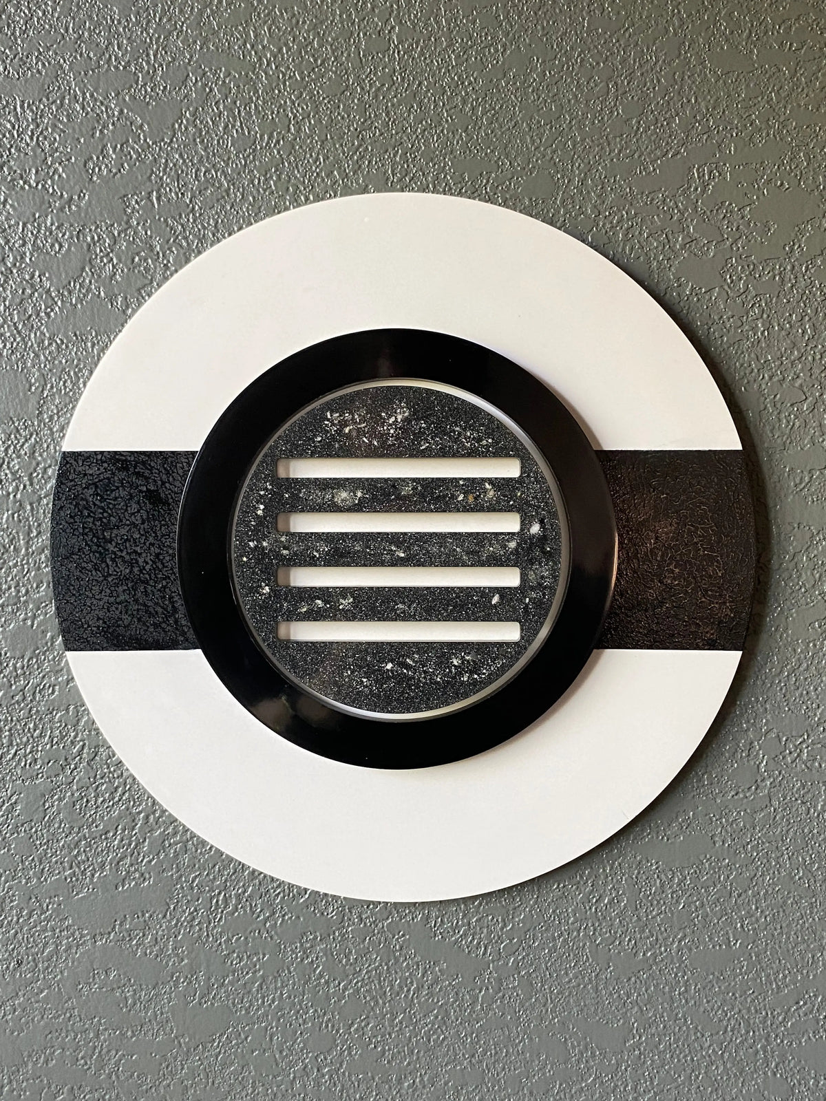 Peekaboo cremation ash memorial wall art with black ring and resin peepholes on white frame
