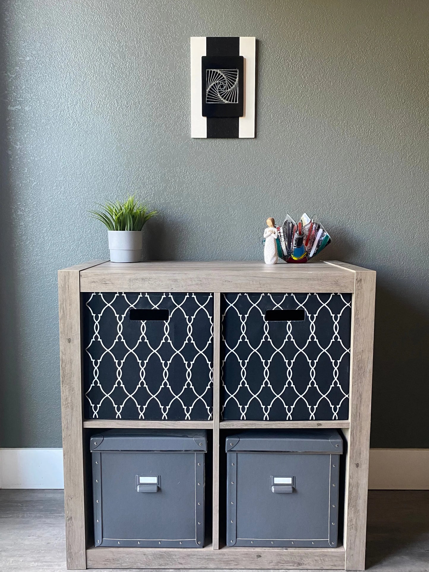 Front view of memorial wall art showing textured black stripe, spiraling resin, and handcrafted white frame