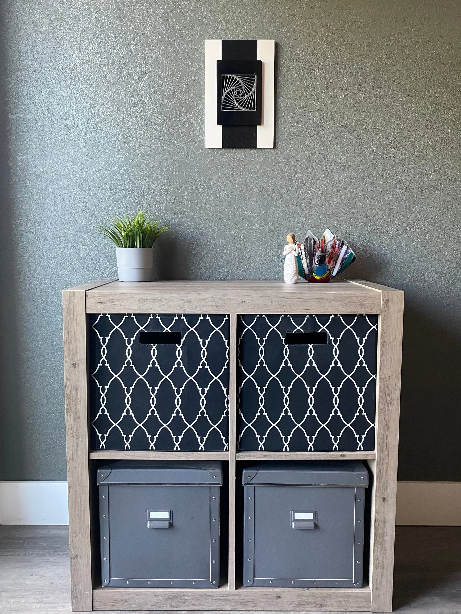 Front view of memorial wall art showing textured black stripe, spiraling resin, and handcrafted white frame