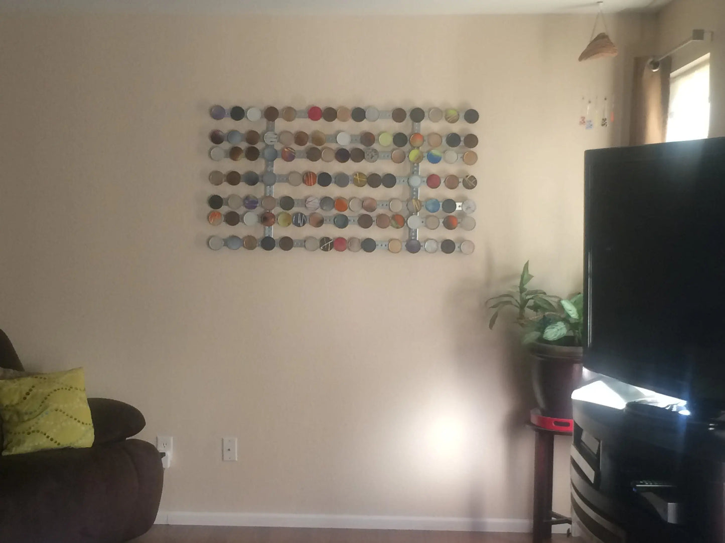 Living room with a wall art piece and a television.