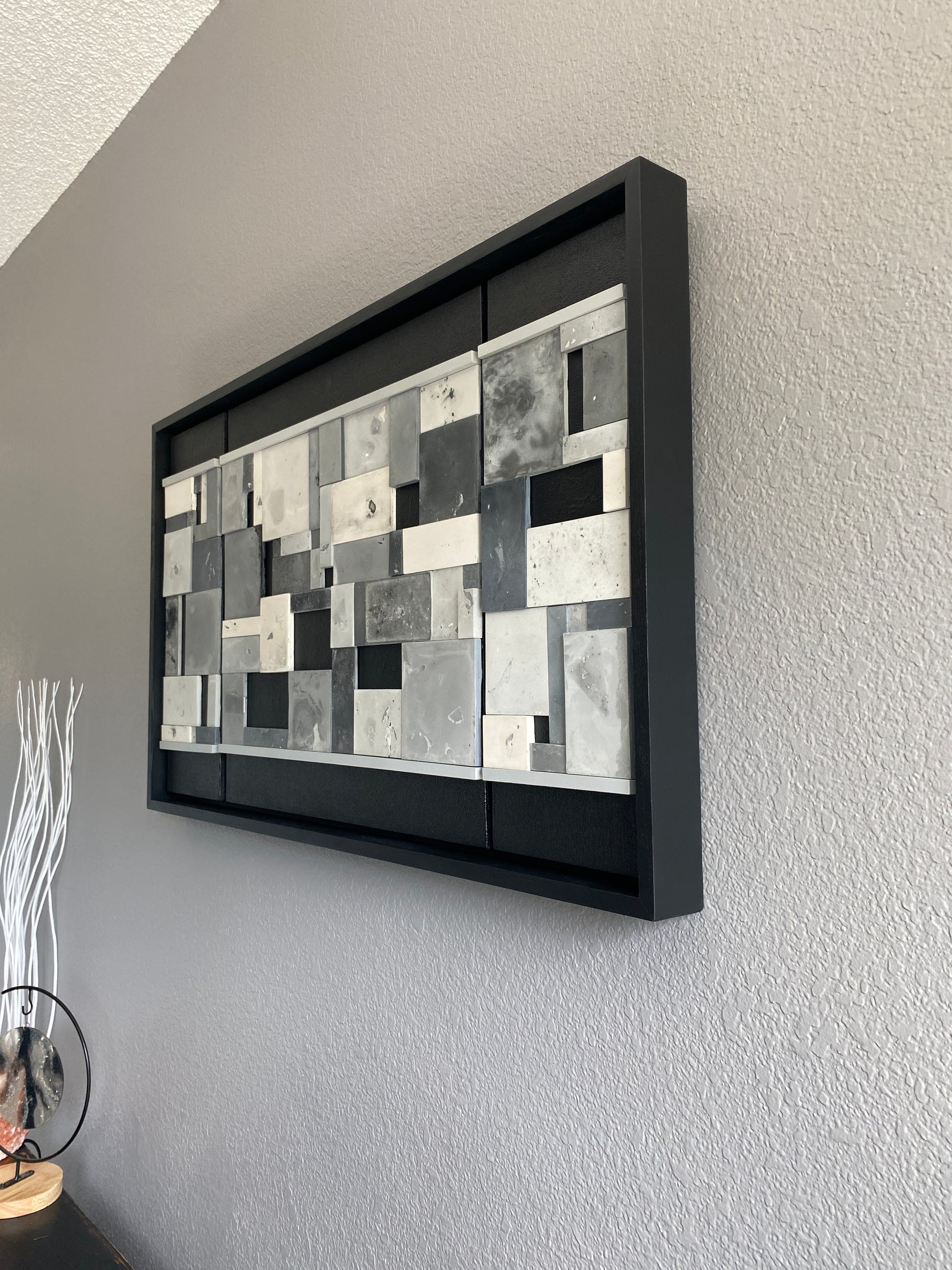 A modern mosaic pattern piece on a plain wall.