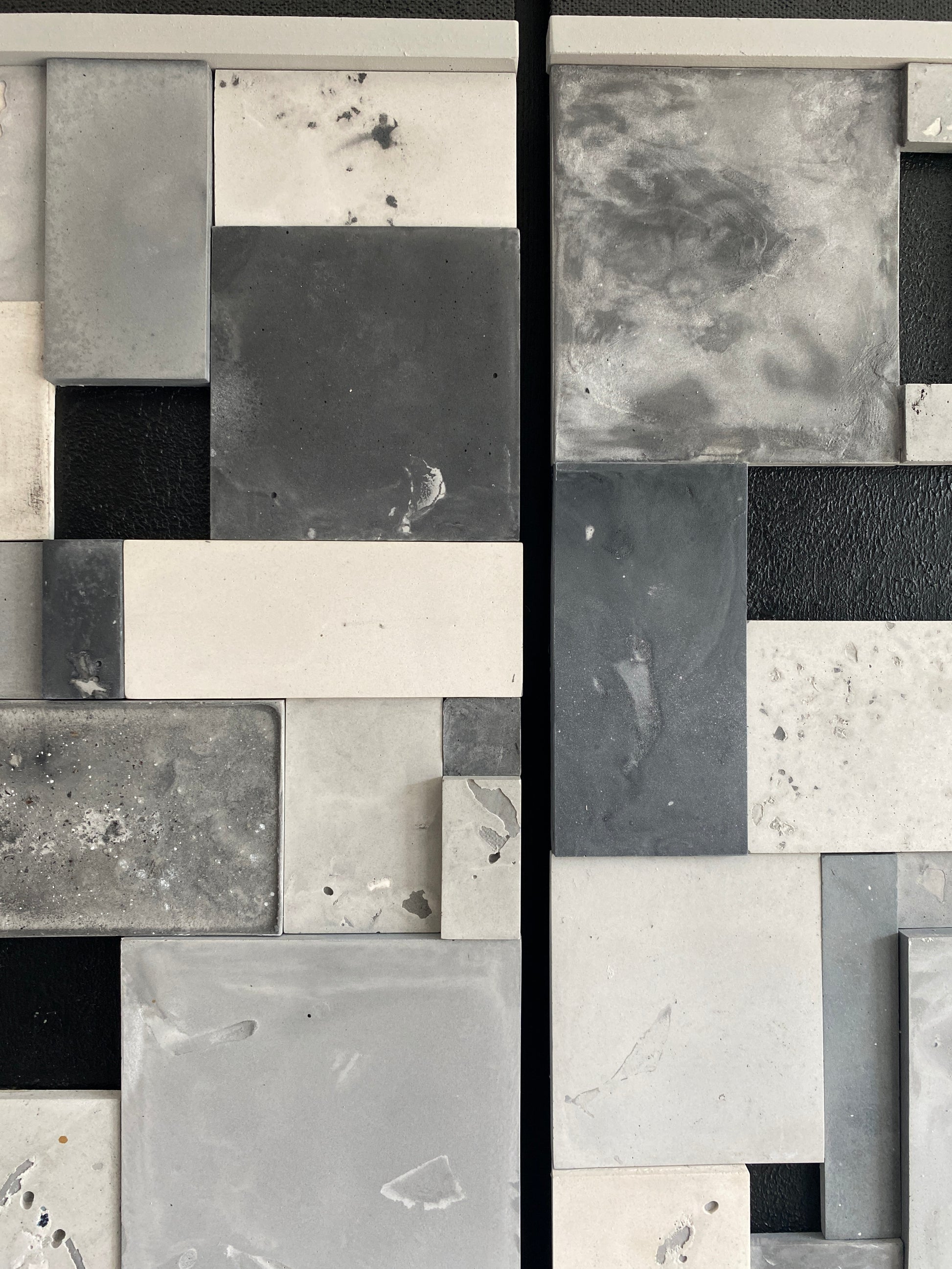 Collage of various gray and black square tiles with different textures.