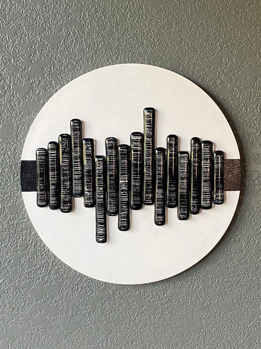 Soundwave cremation ash memorial wall art with glass pieces in wave pattern on white frame and black stripe