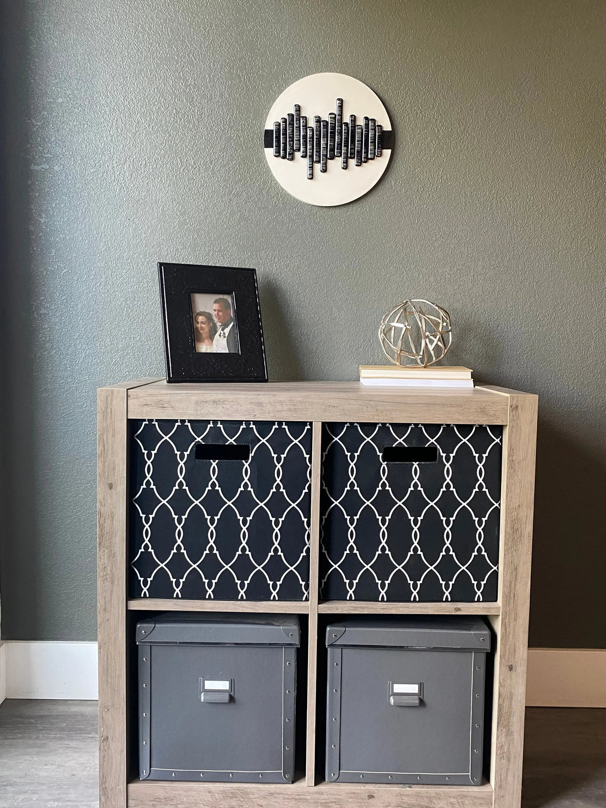 Front view of memorial wall art showing textured black stripe, glass soundwave pattern, and handcrafted white frame