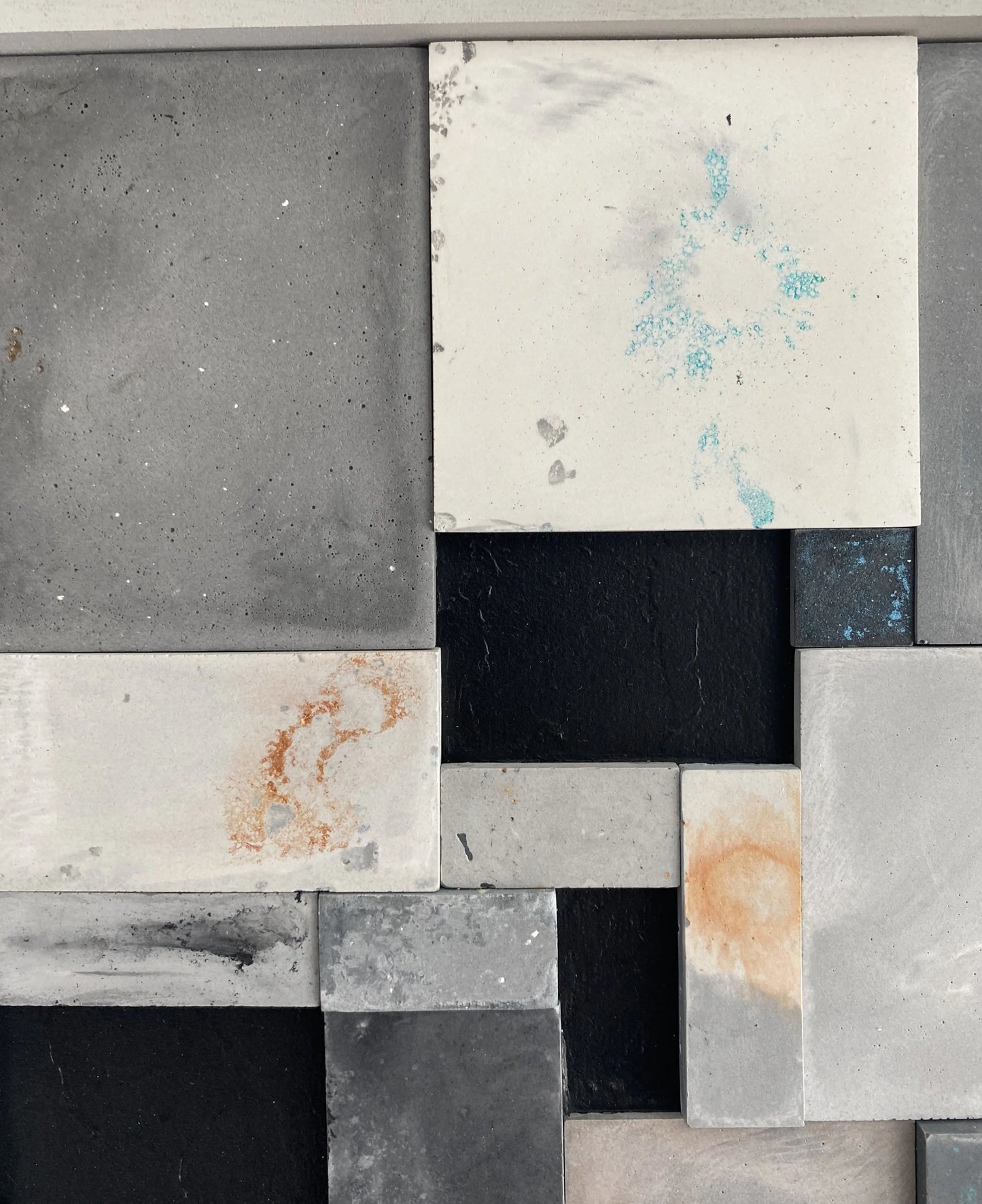 Close-up of various stone tiles with different textures and colors.