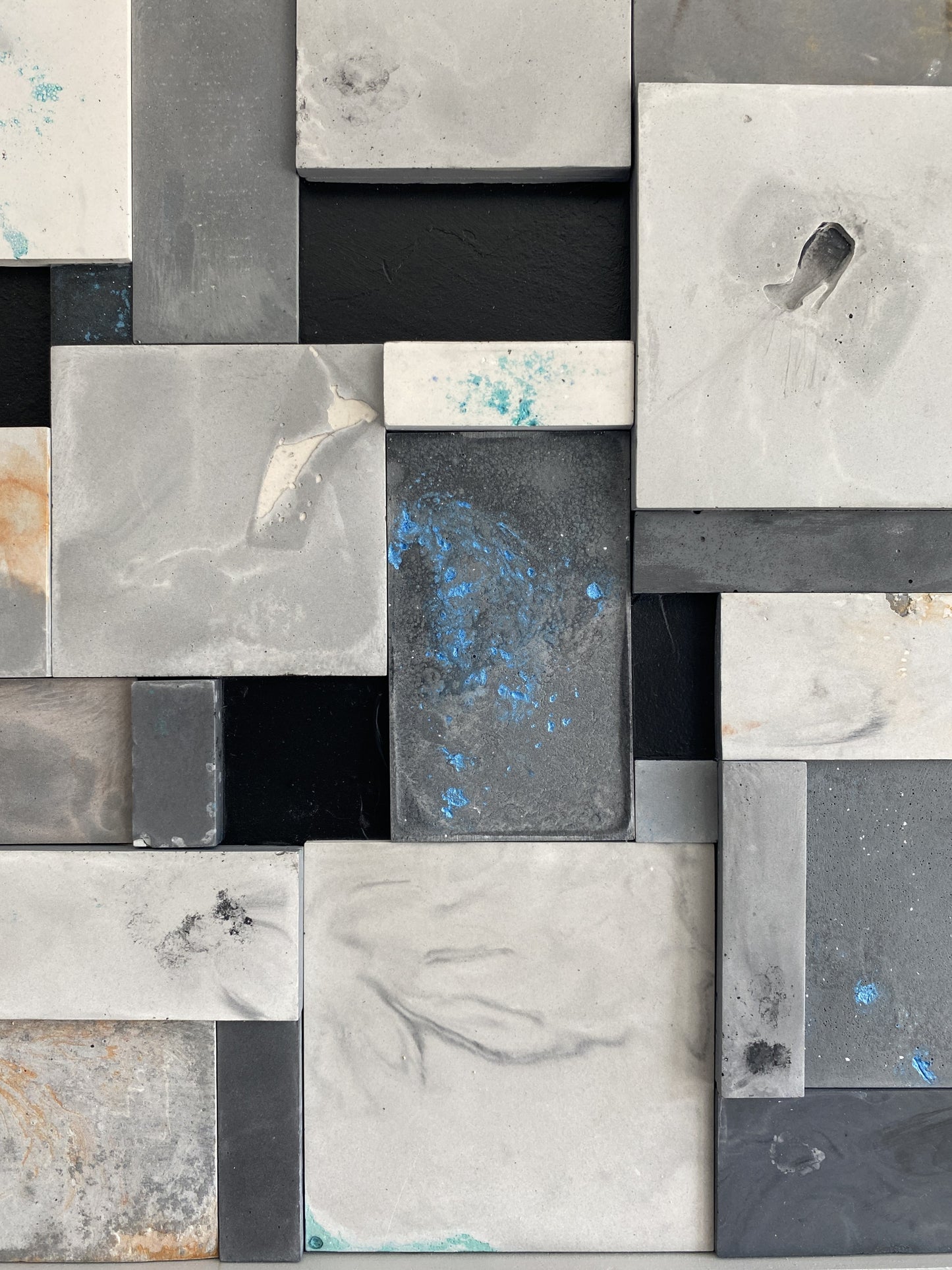 Pattern of square tiles in various shades of gray and black