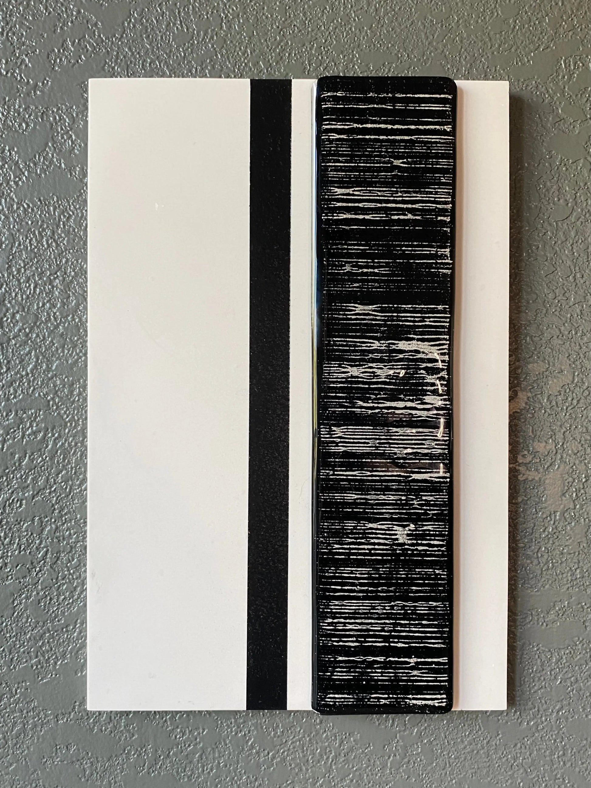 Striped cremation ash memorial wall art with flowing glass stripes on white frame and vertical black accent