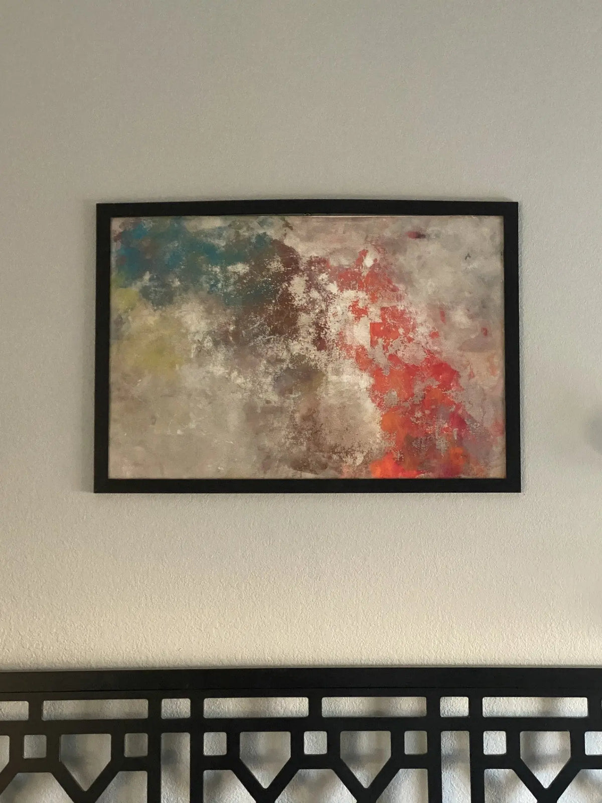 Abstract artwork created with acrylic paint on screen door material, framed in wood with layered, vibrant colors.