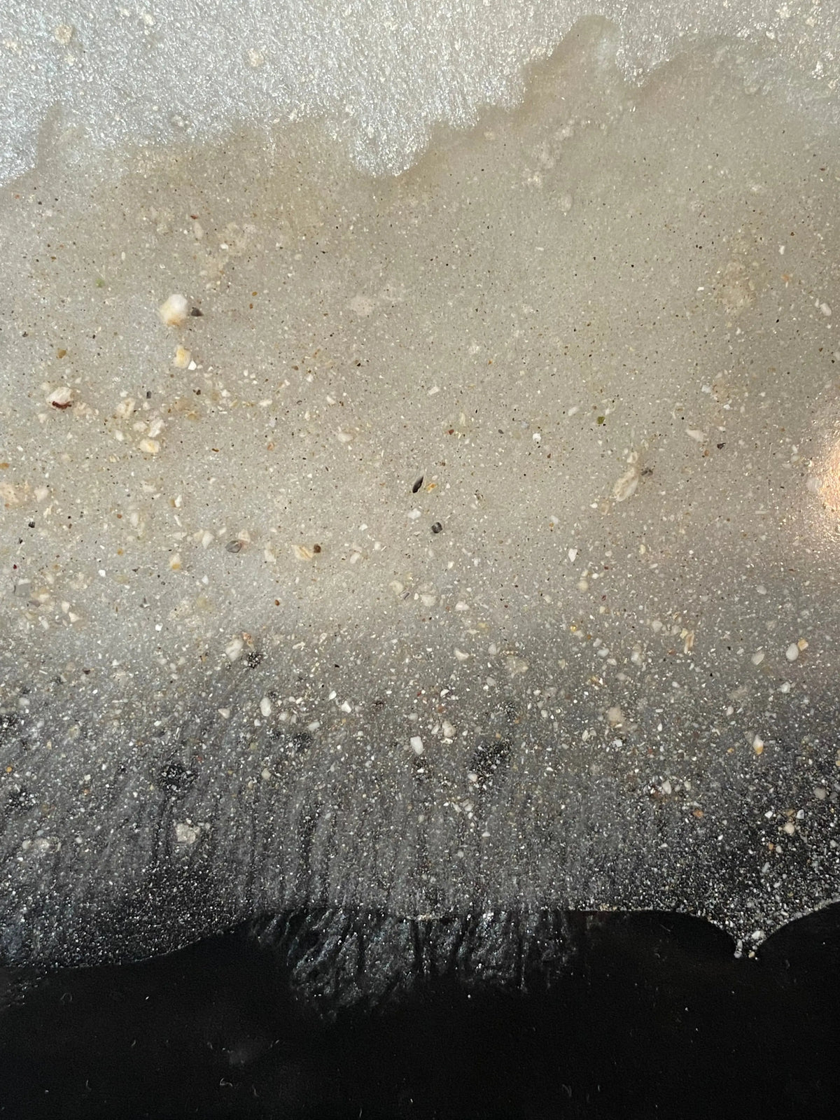 Close-up of flowing tricolor resin infused with cremation ash, symbolizing an unbroken bond