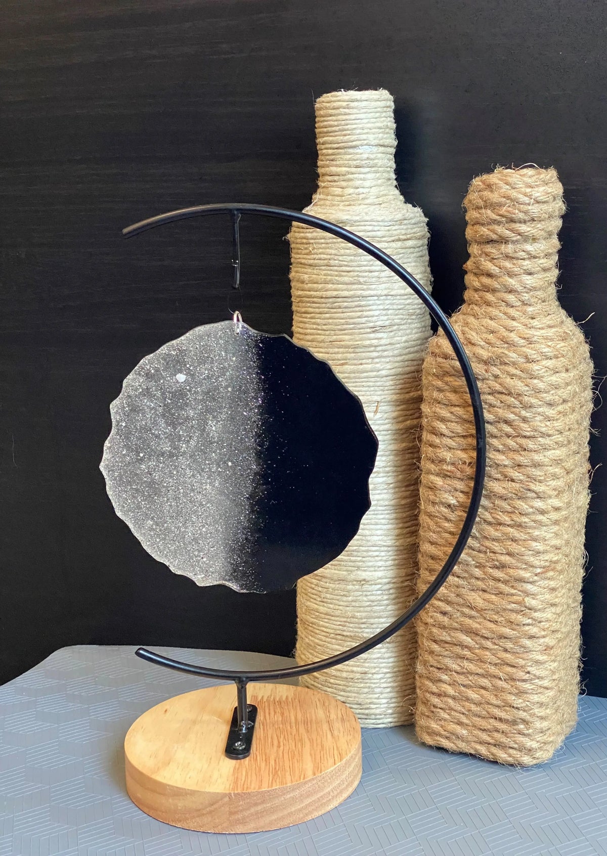 black two-toned ash stand and roped bottles