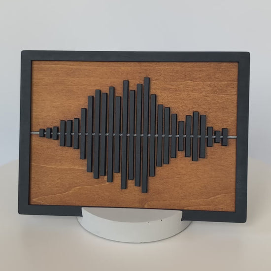Rotating view of the Always With You Sound Wave Wood Display Piece with cement stand, demonstrating the design and shape.