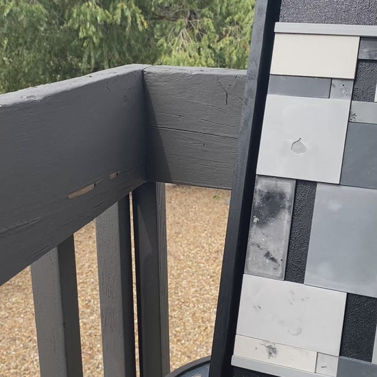 Geometric abstract art sitting on table outside.